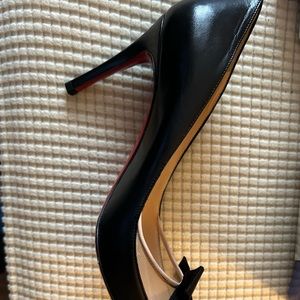 Christian Louboutin black leather pumps. With bow and mesh on side of shoe.